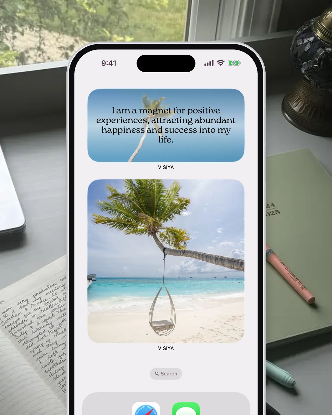 An iPhone home screen with the VISIYA affirmation and vision board widgets