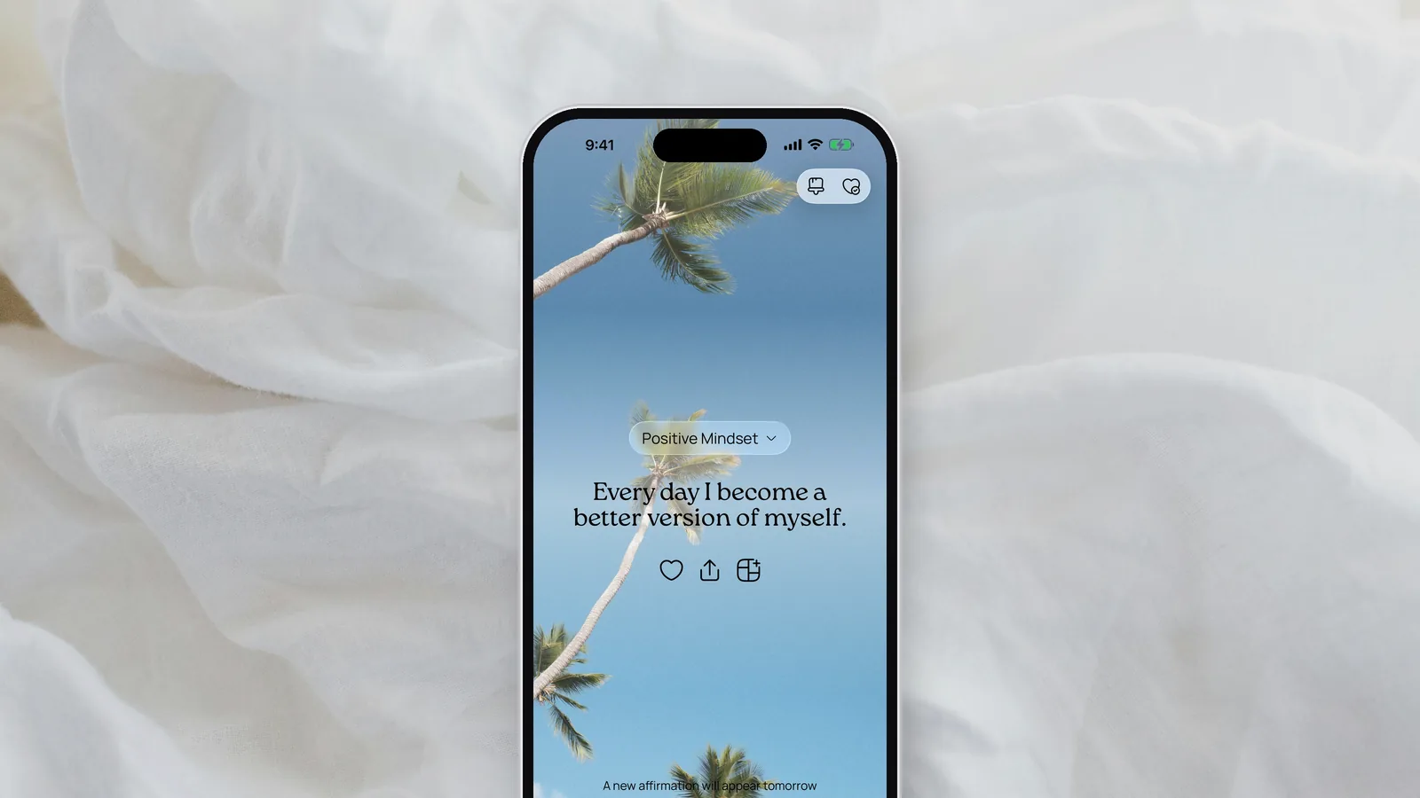 The daily affirmation in the VISIYA app, “Every day I become a better version of myself,” over a sky with palm trees