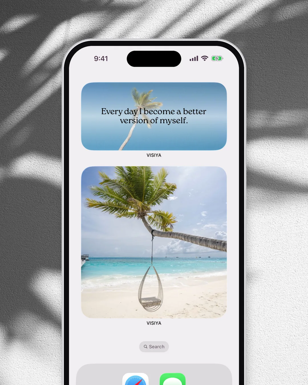 An iPhone home screen with VISIYA's Daily Affirmation widget above a vision board widget
