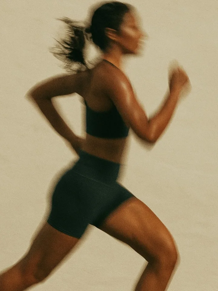 Woman doing yoga on a mat in morning light