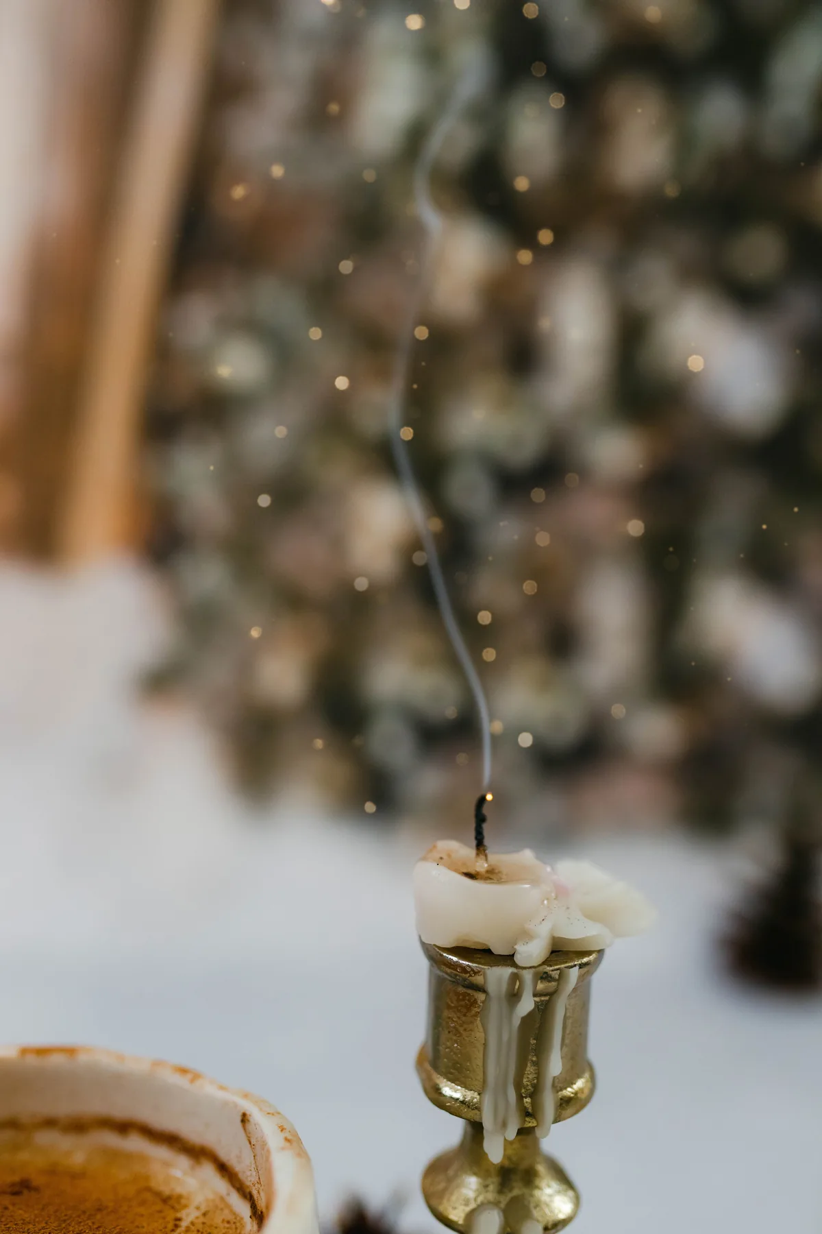 A thin trail of smoke rising from a candle that has just been blown out