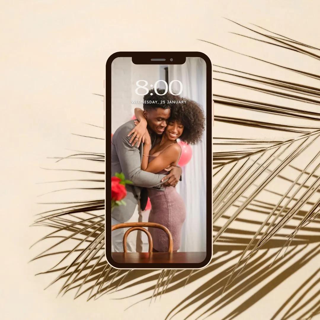 Phone lock screen showing an embracing couple, framed by soft dried palm shadows on beige