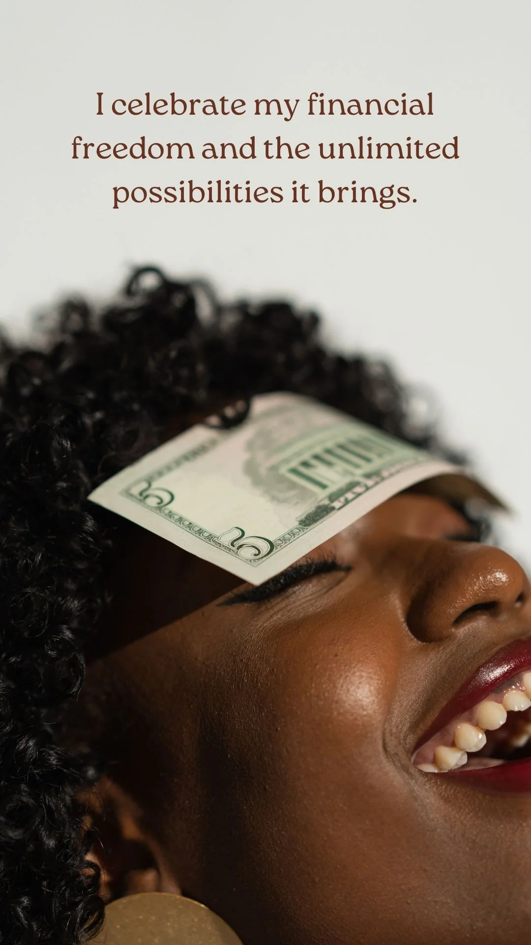 Money affirmation card: a woman smiling with a banknote resting on her face, captioned "I celebrate my financial freedom and the unlimited possibilities it brings."